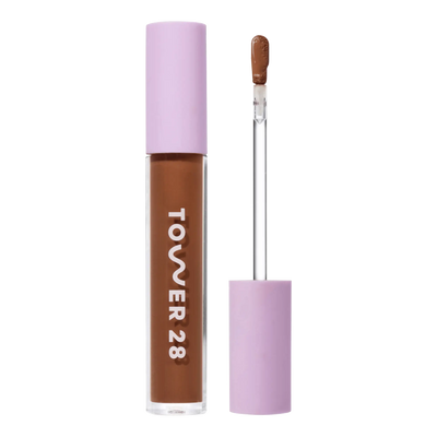 Tower 28 Beauty Swipe Serum Concealer in the shade 17.0 SD, shown with the tube standing upright next to the open applicator wand to reveal the product. [17.0 SD]