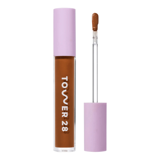 Tower 28 Beauty Swipe Serum Concealer in the shade 18.0 SGV, shown with the tube standing upright next to the open applicator wand to reveal the product. [18.0 SGV]